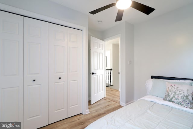 bedroom with a closet, ceiling fan, and light hardwood / wood-style flooring