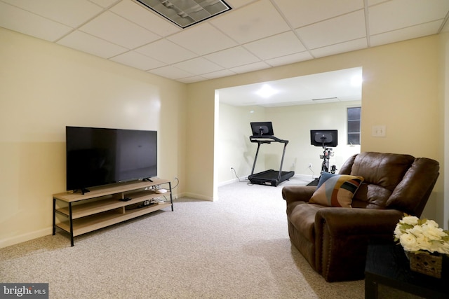 living room featuring light colored carpet and a paneled ceiling