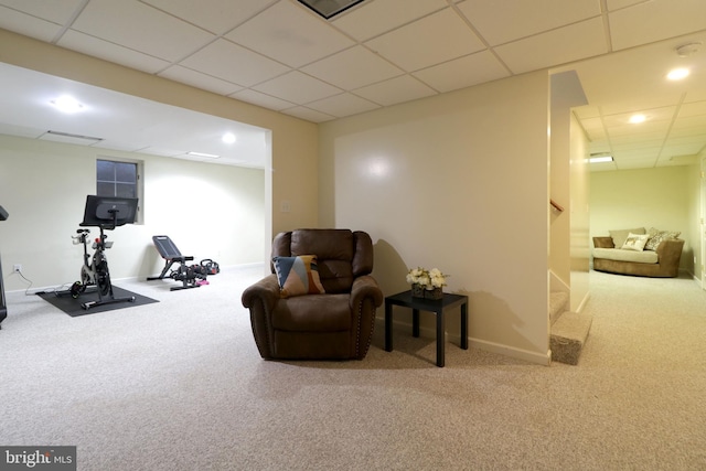 living area with carpet and a drop ceiling