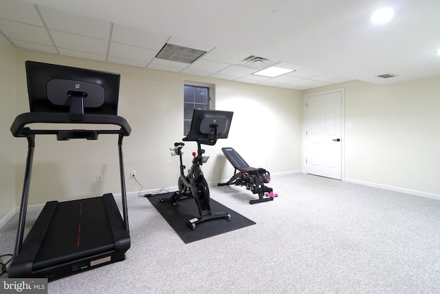 exercise area with carpet flooring and a drop ceiling