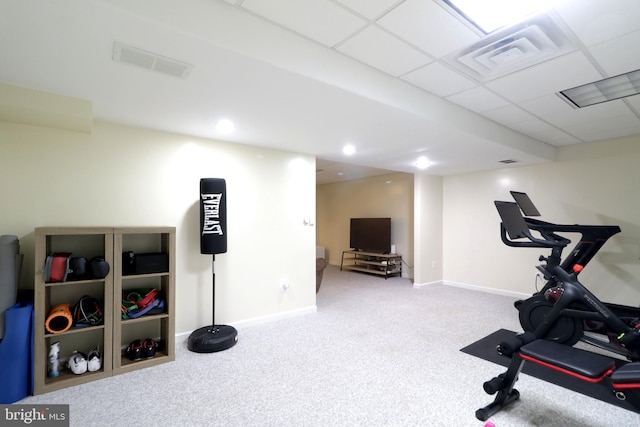 workout room with carpet floors and a paneled ceiling