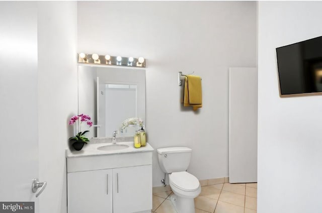 bathroom featuring vanity, tile patterned floors, and toilet