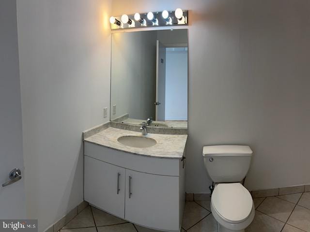 bathroom with vanity, tile patterned floors, and toilet