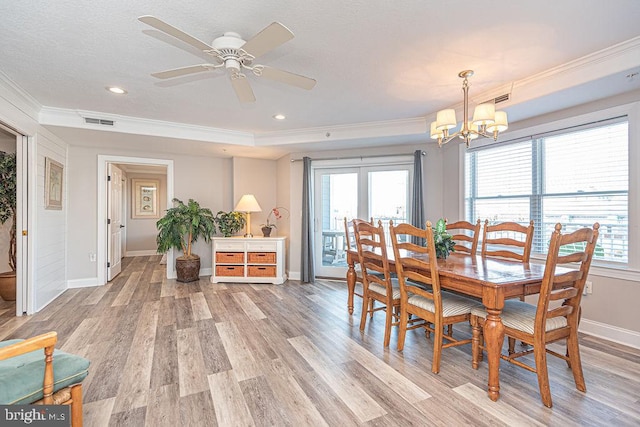 dining room with crown molding, light hardwood / wood-style flooring, and ceiling fan with notable chandelier