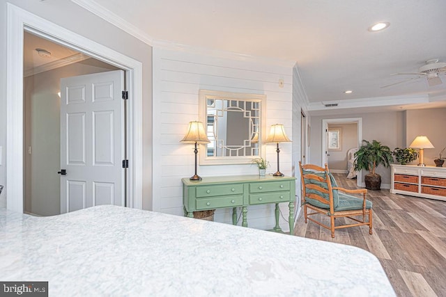 bedroom featuring hardwood / wood-style floors and ornamental molding