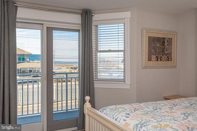 bedroom featuring multiple windows and access to outside