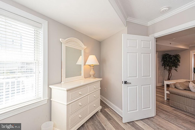 hall featuring crown molding and light hardwood / wood-style flooring