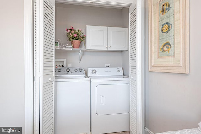 laundry room featuring cabinets and independent washer and dryer