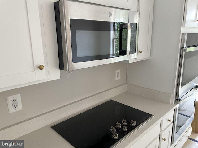 kitchen featuring white cabinetry and stainless steel appliances