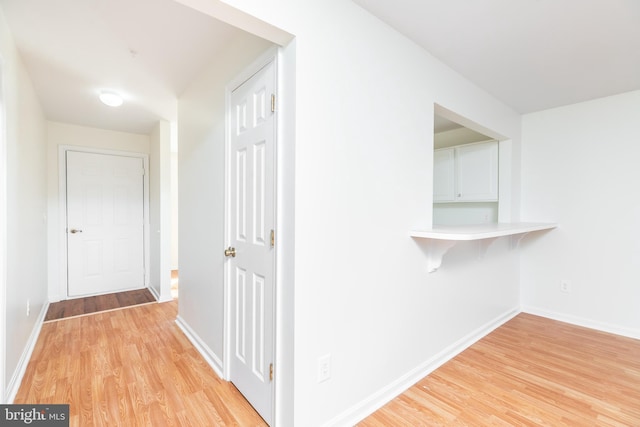 hall with light hardwood / wood-style floors