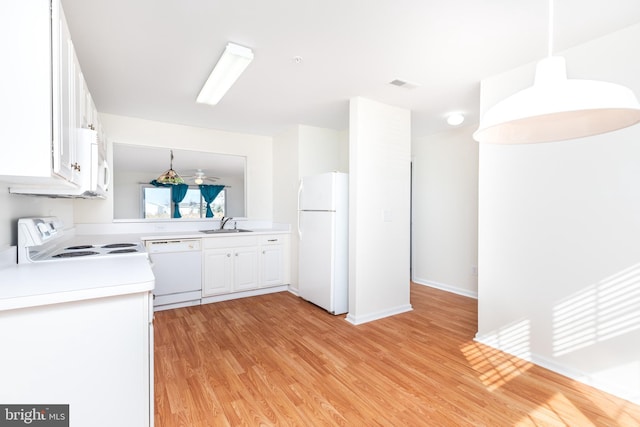 kitchen featuring pendant lighting, sink, white appliances, light hardwood / wood-style flooring, and white cabinetry