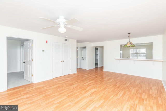 unfurnished living room featuring ceiling fan and light wood-type flooring