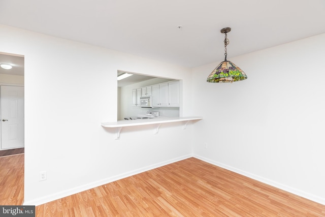 unfurnished dining area featuring light hardwood / wood-style flooring