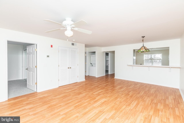 unfurnished living room featuring ceiling fan and light hardwood / wood-style floors