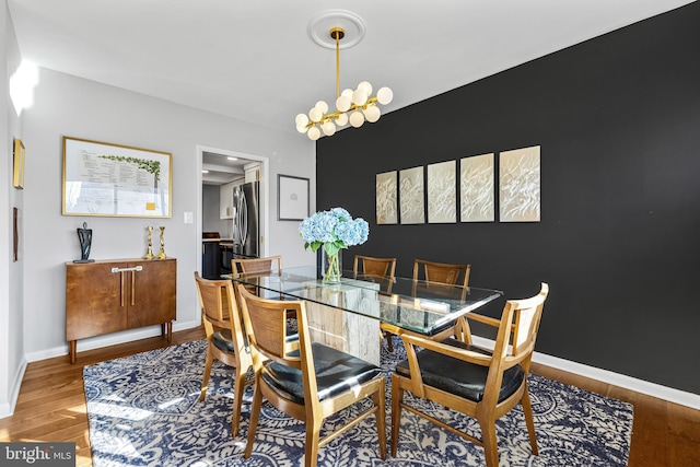 dining room featuring hardwood / wood-style floors and a notable chandelier