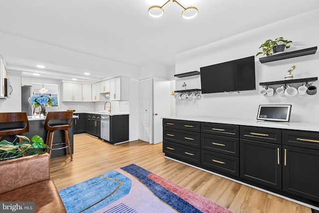 living room with sink and light hardwood / wood-style flooring