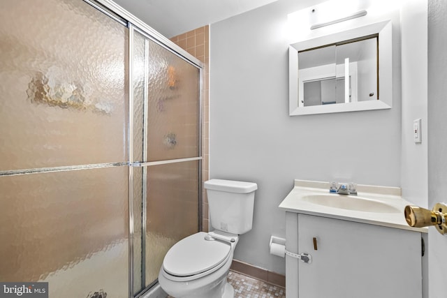 bathroom with vanity, a shower with shower door, and toilet