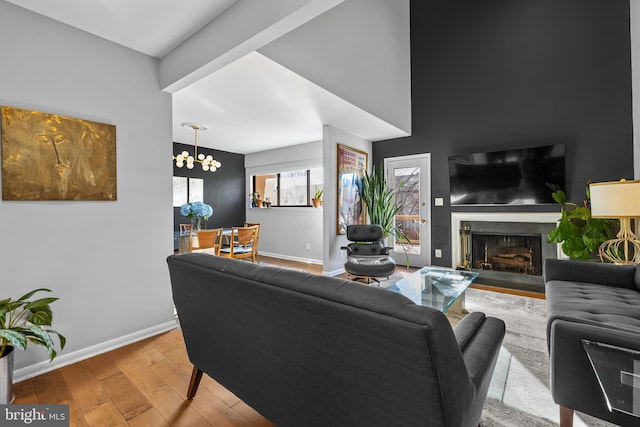 living room with a notable chandelier and light hardwood / wood-style flooring