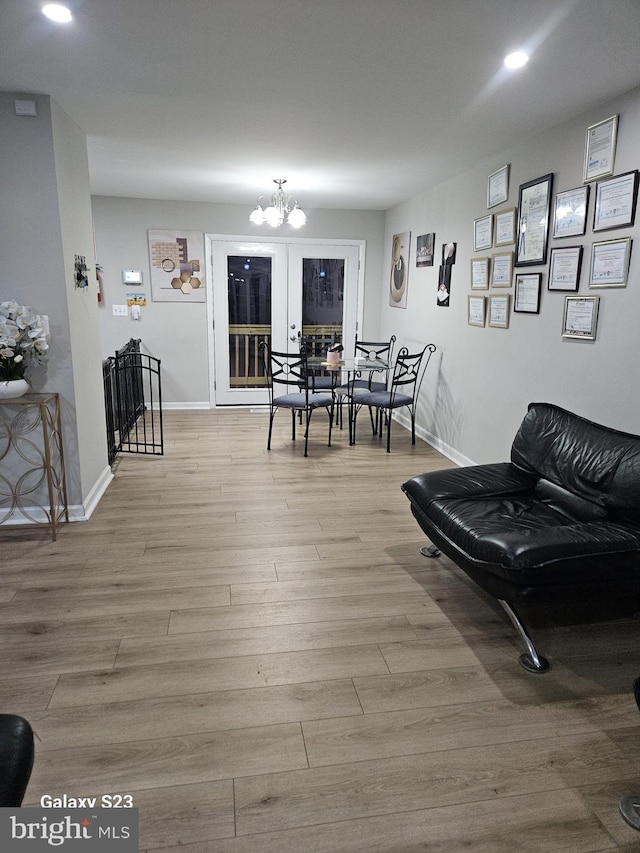 dining area with light hardwood / wood-style flooring and a chandelier