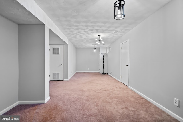 spare room featuring carpet flooring, baseboards, and visible vents