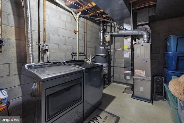 utility room featuring gas water heater and washing machine and dryer