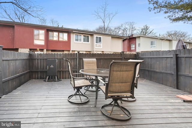 deck featuring outdoor dining area and fence