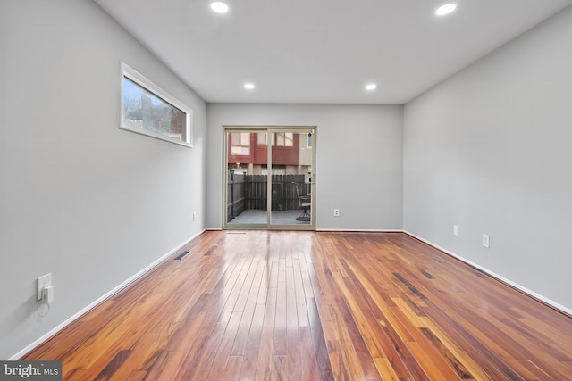 unfurnished room with recessed lighting, baseboards, and hardwood / wood-style floors