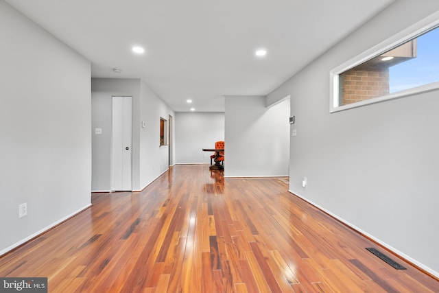 spare room featuring visible vents, recessed lighting, baseboards, and hardwood / wood-style flooring