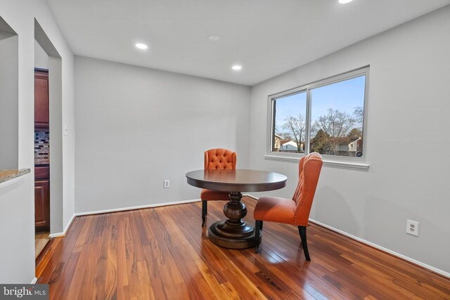 dining space with recessed lighting, baseboards, and wood-type flooring