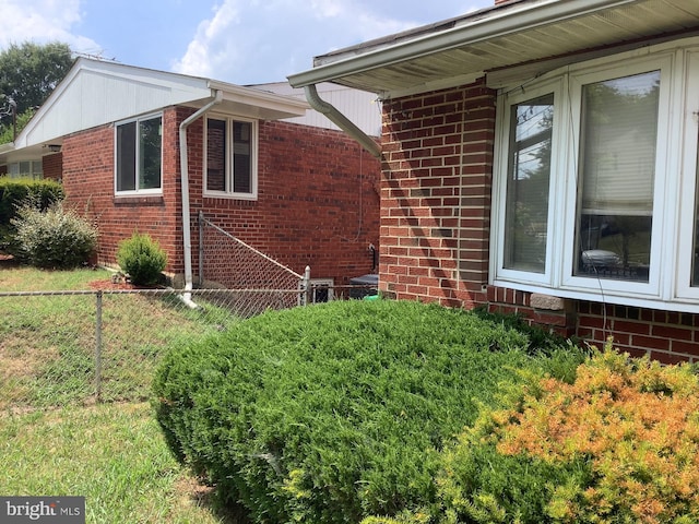 view of side of home featuring a lawn