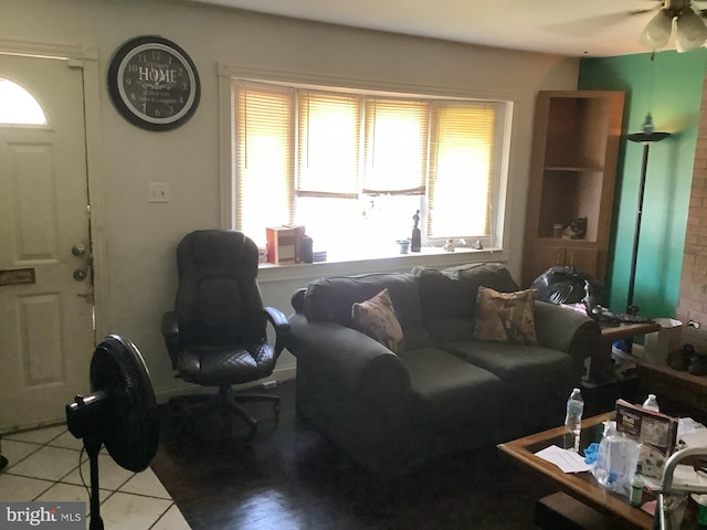 tiled living room with ceiling fan