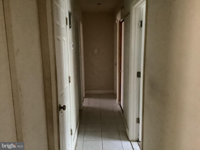 corridor with light tile patterned floors