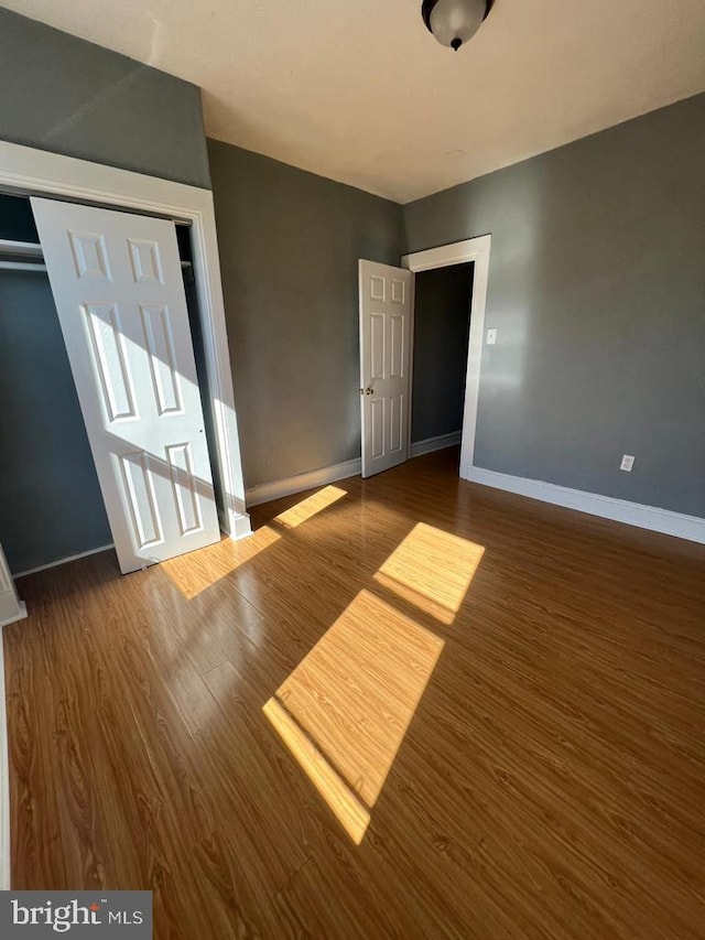 unfurnished bedroom with wood-type flooring