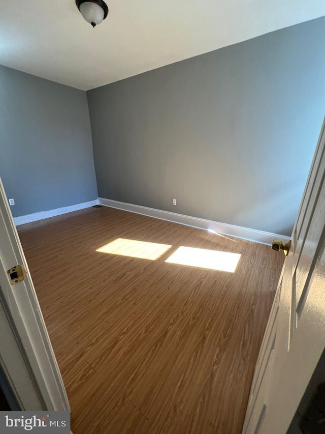 spare room featuring dark hardwood / wood-style flooring