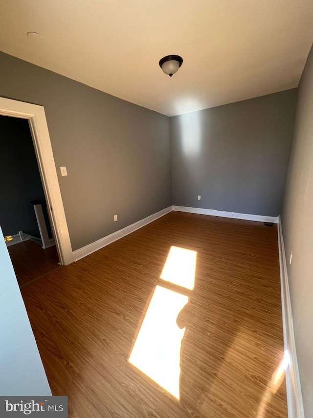 empty room with hardwood / wood-style flooring