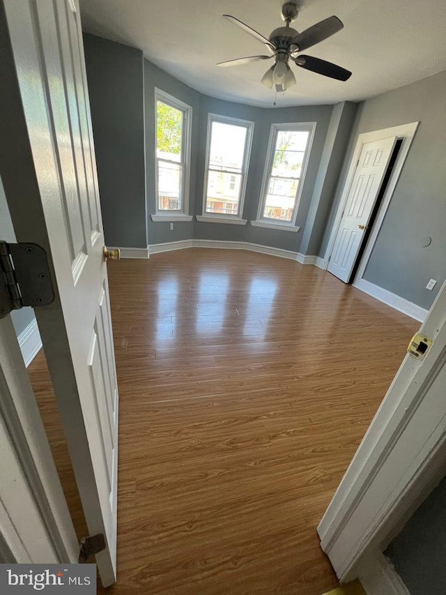 spare room with wood-type flooring and ceiling fan