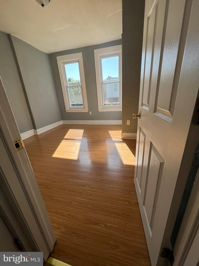 bonus room with dark wood-type flooring