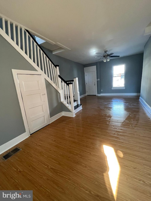 unfurnished living room with hardwood / wood-style flooring and ceiling fan