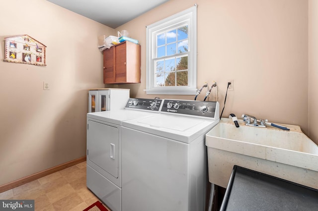 clothes washing area with washer and dryer and sink