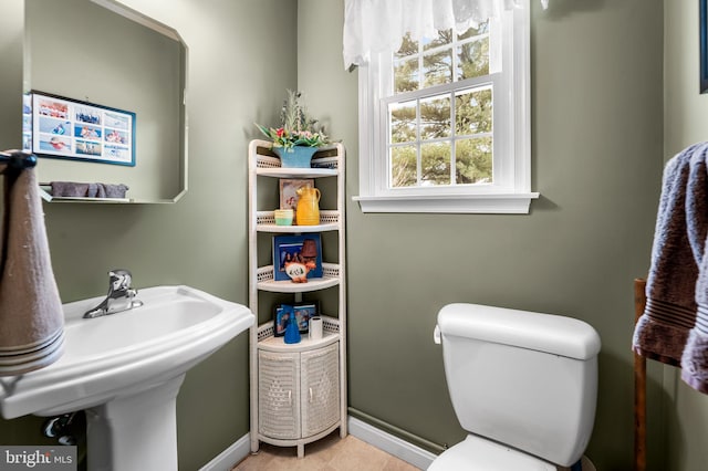 bathroom featuring sink, toilet, and tile patterned floors