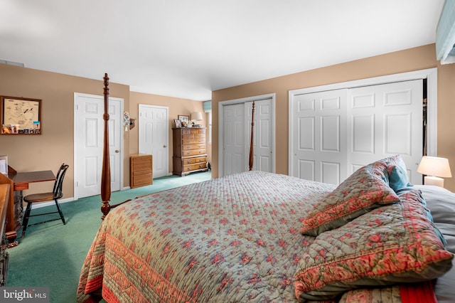 bedroom featuring multiple closets and carpet flooring