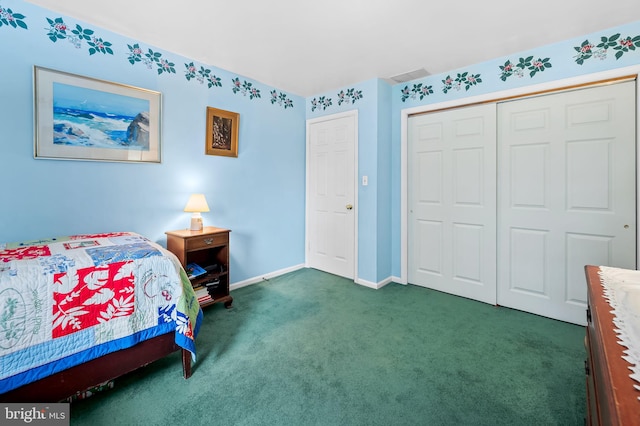 bedroom with dark carpet and a closet