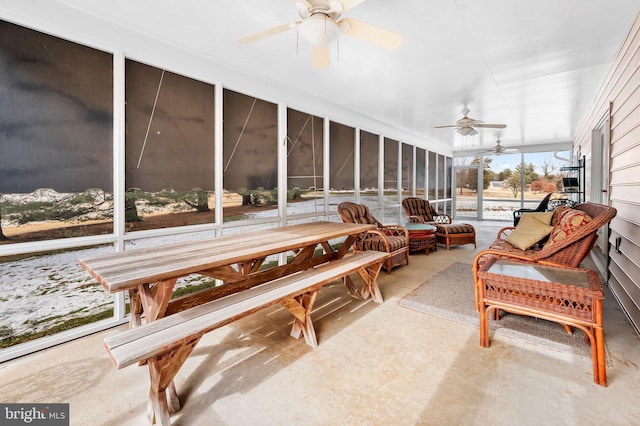 sunroom / solarium featuring ceiling fan