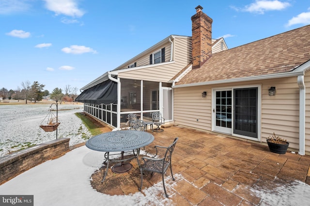 view of patio featuring a sunroom