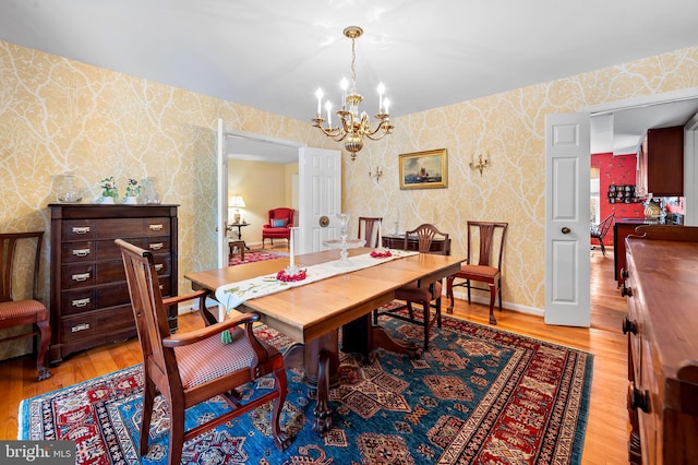 dining room with a notable chandelier and light wood-type flooring