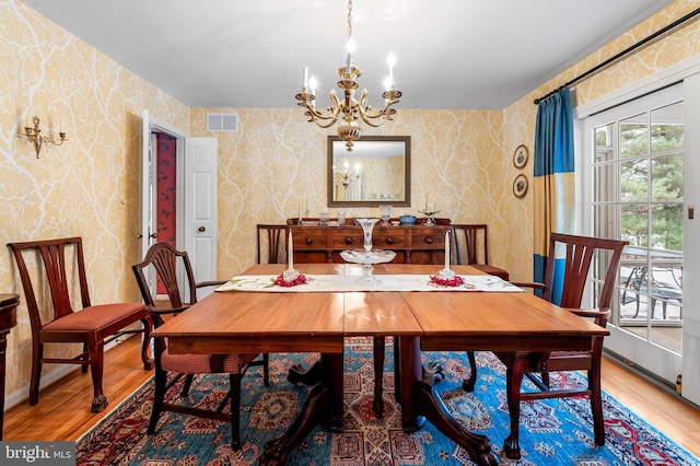 dining room featuring hardwood / wood-style flooring and a notable chandelier