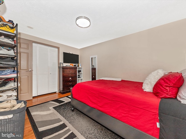 bedroom featuring hardwood / wood-style flooring and a closet