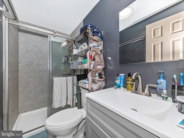 bathroom with vanity, toilet, and walk in shower