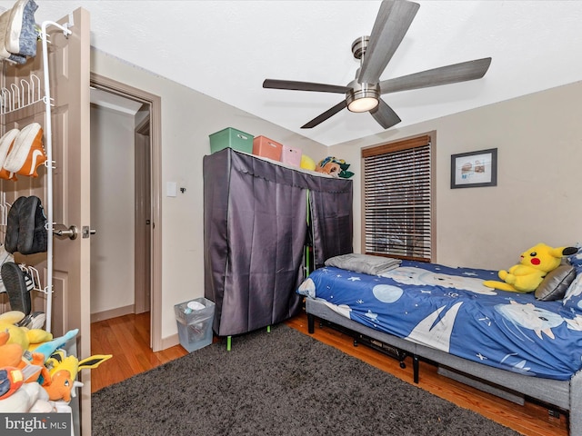 bedroom with hardwood / wood-style floors and ceiling fan