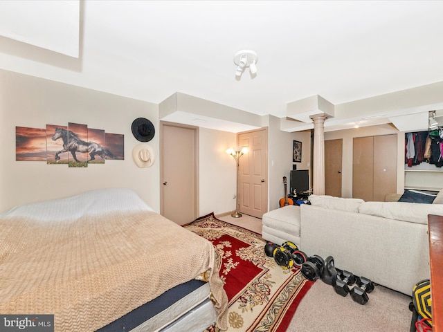 carpeted bedroom featuring ornate columns